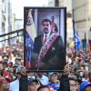 A supporter of ousted Venezuelan President Nicolas Maduro carries his portrait during a rally outside the National Assembly in Caracas on January 5, 2026.