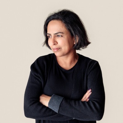 Woman wearing black staring off screen to the left.